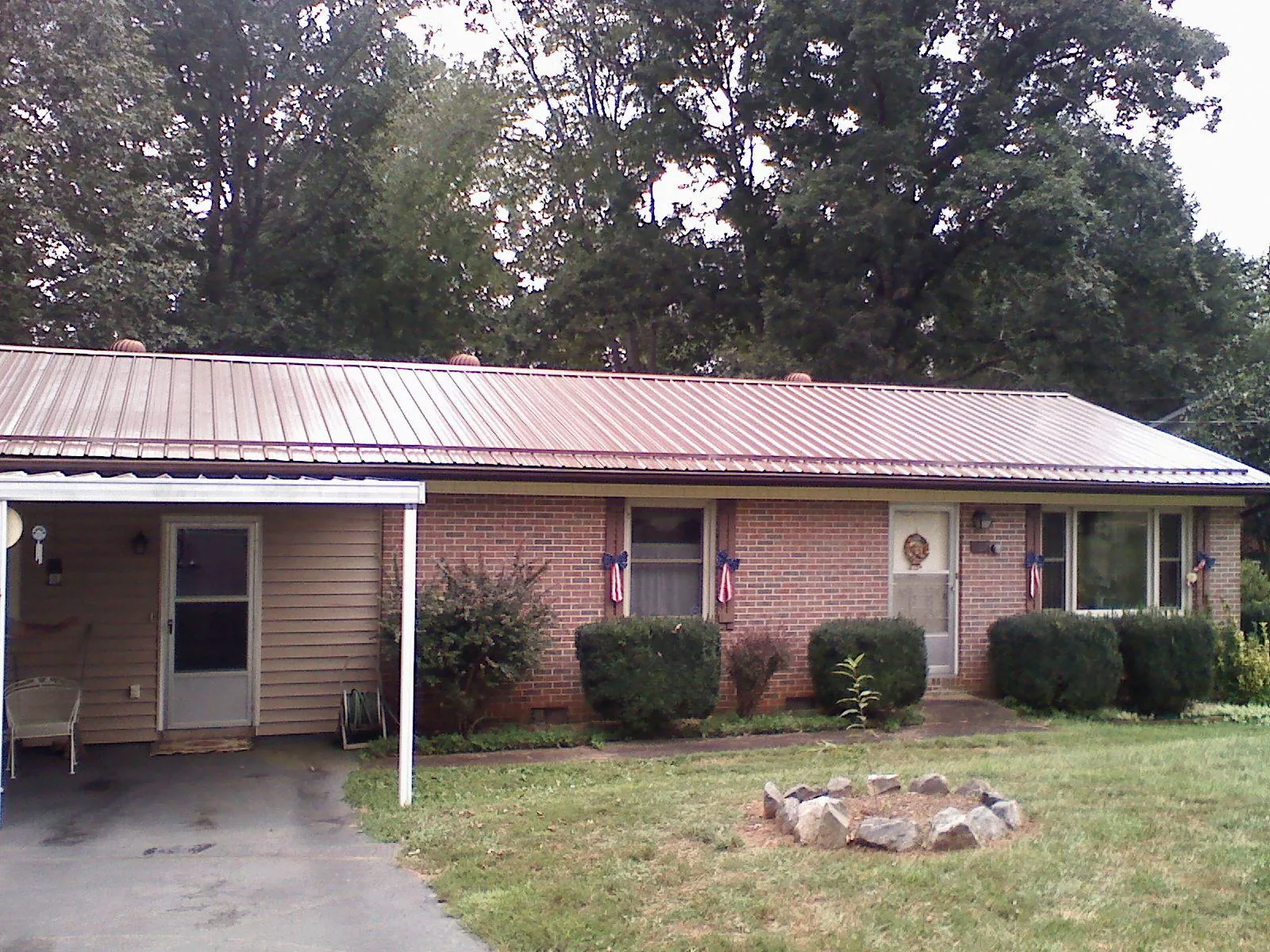 Bronze metal roof and carport on a brick ranch home — Roof Repair work by our crew in Blue Ridge