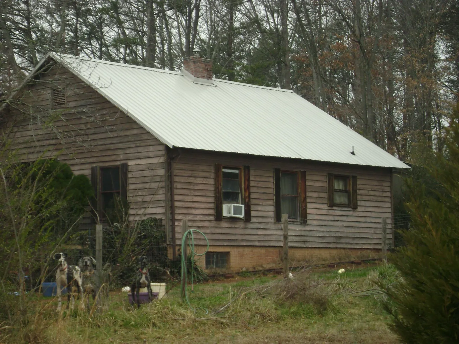 White metal roof on an old wood sided farmhouse, from a Metal Roof Installation job in Blue Ridge